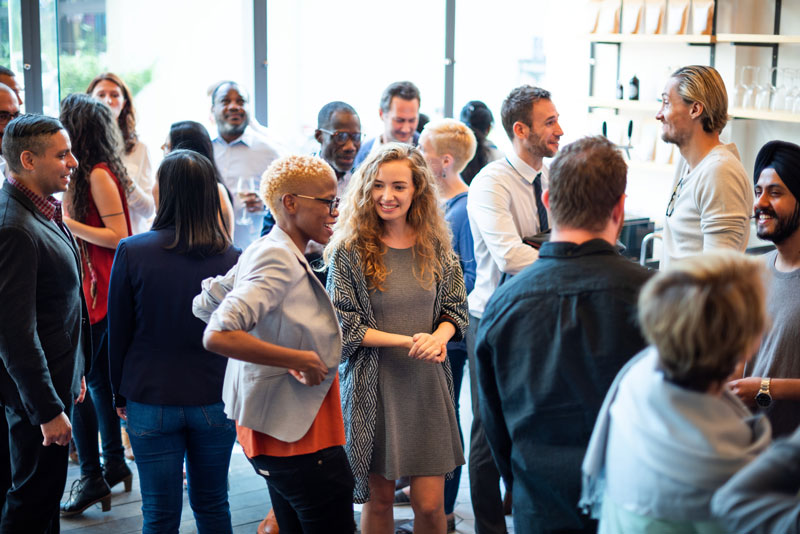 Professionals networking and talking at a business event, representing Nevada’s collaborative business environment.